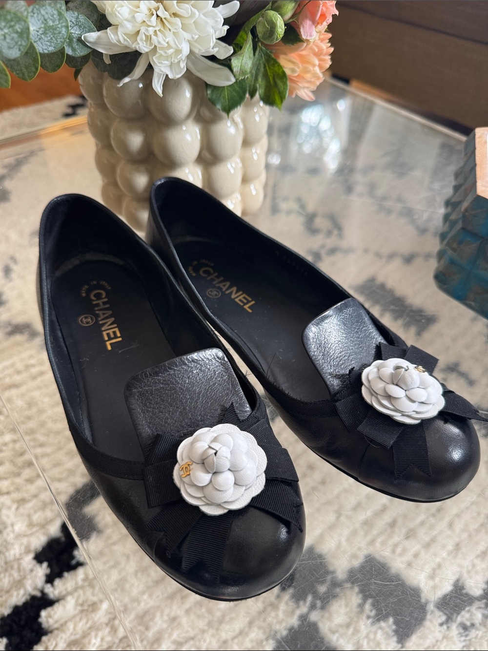 CHANEL Black Leather Ballet Flats with White Camellia Appliqué